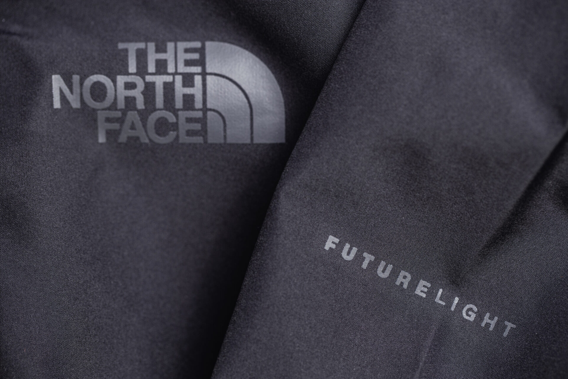 The North Face logo on black jacket with Futurelight technology,